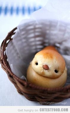 there is a small figurine in the basket with it's eyes closed