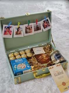 an open suitcase filled with assorted items on top of a white carpeted floor