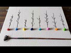 an art project with different types of branches and balls on the paper, including paintbrushes