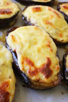 baked stuffed mushrooms with cheese on them sitting on a baking sheet, ready to be eaten