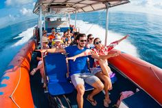 a group of people riding on the back of a boat