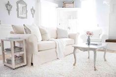 a living room filled with furniture and white walls