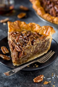 a slice of pecan pie on a black plate