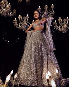 This lehenga set features platinum cut sequin and crystal embellishment in a cascade motif pattern. The ensemble is paired with a criss-cross back and fully embroidered net dupatta.From Seema Gujral's Tuscan Summer collection. DELIVERY TIMEPlease allow 4 months for your outfit to arrive. FABRIC DETAILSNet Professional cleaning only. Extravagant Lehenga, Lehenga Prom, Champagne Lehenga, Pretty Lehengas, Silver Lehenga, Beautiful Lehengas, Gota Patti Lehenga, Tuscan Summer, Strappy Blouse