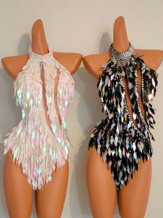 two mannequins with different colored feathers on them