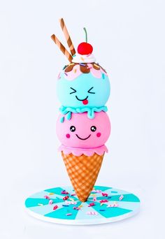 an ice cream cone with two different colored frosting on top and one has a smiling face