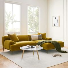 a living room scene with focus on the couch and coffee table in the foreground