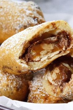 a basket filled with pastries covered in powdered sugar