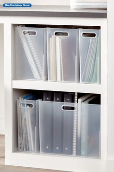 a white bookcase filled with files and folders