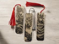 three wooden bookmarks with tassels hanging from them