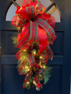 a christmas wreath hanging on the front door