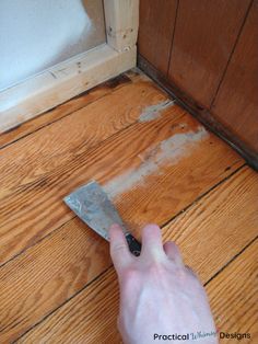 a person using a knife to cut through the floor