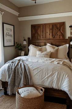 a bed with white linens and pillows in a bedroom next to a wooden headboard