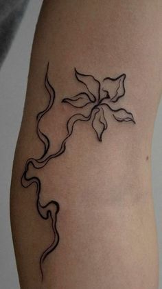 a woman's arm with a tattoo on it that is shaped like a flower