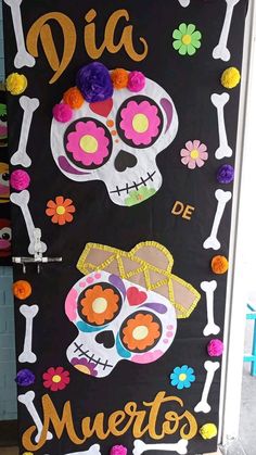 a door decorated with colorful paper flowers and sugar skulls for dia de muertos