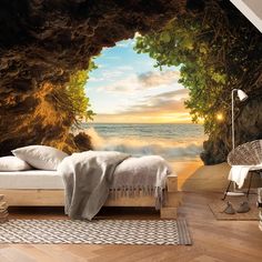 the bedroom is decorated in natural wood and has an ocean scene wall mural on it