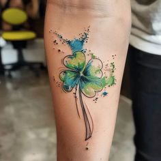 a woman's leg with a shamrock tattoo on it