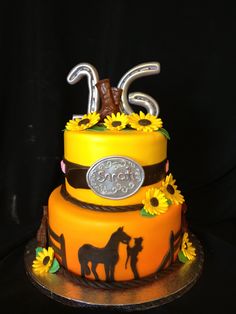 a three tiered cake decorated with sunflowers and horses