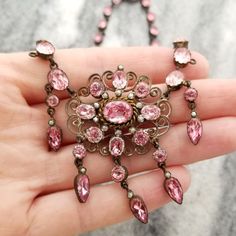 This is a stunning antique pink paste necklace. Each stone is bezel set in silver and there is a slight graduated size from back to front. There are two missing drops. Others wise in good wearable condition. The necklace measures 16 Inches long The center measures 2 Inches long 1 3/8 inch wide It is unmarked but tests as being made from silver The necklace weighs 29.7 grams It is in wearable condition. It is missing two drops. It does show some wear and tarnish and could use a cleaning. Please i Pink Necklace Aesthetic, Antique Jewelry Necklace, Antique Pink, Pink Necklace, Drop Pendant, Collar Necklace, Vintage Watches, Antique Jewelry, Vintage Antiques