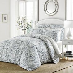 a bed with blue and white comforters in a room