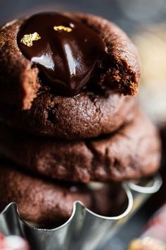 three chocolate cookies stacked on top of each other with a bite taken out of one