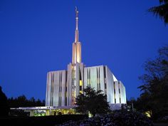 a tall building with a steeple lit up at night