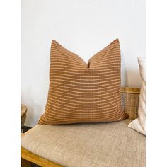 a brown pillow sitting on top of a wooden chair