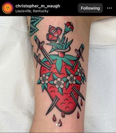 a tattoo on the leg of a woman with scissors and a strawberry in it's center