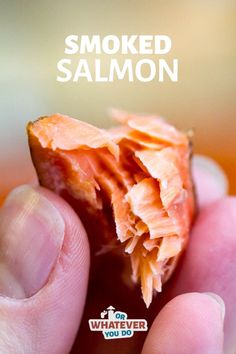 someone holding up a piece of smoked salmon in their hand with the words smoked salmon on it