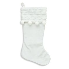 a white christmas stocking with pom - poms hanging from it's side