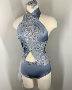 a mannequin wearing a blue dress with silver sequins