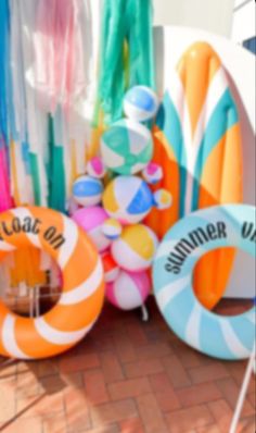 an assortment of inflatable floats and beach toys on the ground at a fair