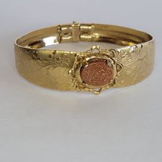 Beautiful vintage bracelet gold tone. With a stone in the center. Great condition. Fit for a small wrist or a teen. Diameter 1 inch. Antique Gold Bracelet Stamped 14k, Antique 14k Stamped Gold Bracelet, Gold Oval Bracelet Stamped 14k, Vintage Yellow Gold Bracelet Jewelry, Antique Gold Cuff Bracelet With 17 Jewels, Vintage Gold-tone Jewelry For Anniversary, Vintage Oval Gold Bracelet For Formal Occasions, Vintage Yellow Gold Bracelet, Vintage 14k Gold Oval Bracelet