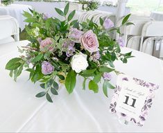 a bouquet of flowers sitting on top of a table next to a sign that says i do