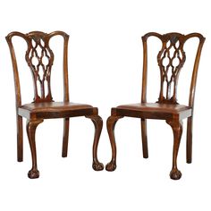 a pair of wooden chairs sitting next to each other