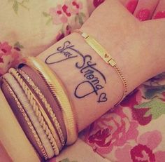 a woman's wrist tattoo with the words i love you