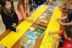 four children sitting at a table writing on yellow paper