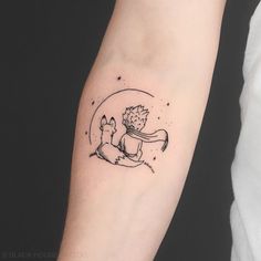 a small tattoo on the arm of a person with a hedgehog and fox design