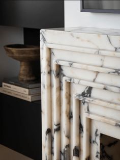 a white marble fireplace surround in a living room