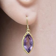 The first marquise cut was commissioned by King Louis XV, who asked a jeweler to facet a stone such that it resembled the lips of his mistress - Jean Antoinette Poisson, the Marchioness Madame de Pompadour. 14k solid gold paired with faceted amethyst stone.French backs for pierced ears. Size: 7/8 Inch. Elegant Marquise Amethyst Jewelry, Luxury Marquise Gemstone Earrings, Luxury Marquise Cut Earrings Gift, Luxury Marquise Cut Earrings As Gift, Marquise Amethyst Jewelry Gift, Marquise Amethyst Jewelry For Gift, Marquise Gemstone Earrings For Wedding, Gift Marquise Amethyst Jewelry, Elegant Purple Marquise Jewelry