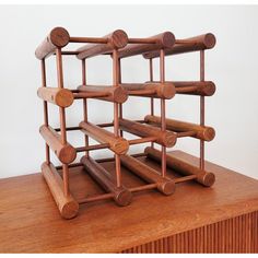 a wooden wine rack sitting on top of a table