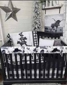 a black and white baby crib with pictures on the wall