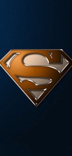 the superman logo is shown on a dark blue background with gold accents and silver letters