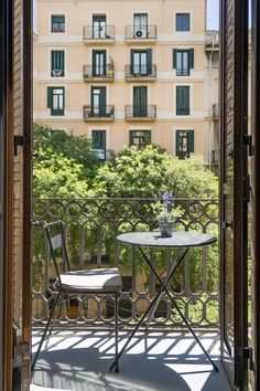 an open door with a table and chairs on it