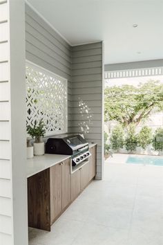 an outdoor kitchen with a grill on the counter