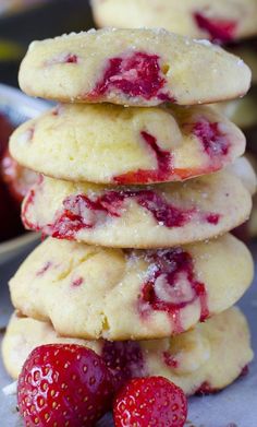 a stack of strawberry shortbread cookies with powdered sugar