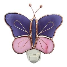 a purple and pink butterfly light switch cover on a white wall mounted outlet with wire