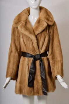 For Sale on 1stDibs - c. 1970 mink jacket in a soft golden shade features a spread collar and comes with a brown leather sash belt. One fur hook and an interior tie keep allow Formal Brown Fur Coat For Fall, Luxury Brown Evening Outerwear, Classic Brown Fur Coat For Formal Occasions, Mink Jacket, Mink Coat, Mink Fur Coat, Personal Aesthetic, Sash Belts, Sash Belt