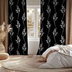 a bed room with a large window and a plant design on the curtain rod ends