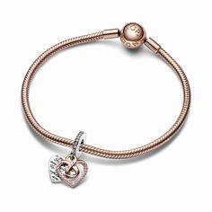 A jewelry gift for a mom who will always be perfect to you, just as she is. The Two-tone Infinity Heart Double Dangle Charm features an openwork heart dangle in 14k rose gold plating forming an infinity symbol in the center, adorned with a row of pink pavé and engraved with the word "Mom" with a pink stone as the central letter. Behind it is a sterling silver heart-shaped disc engraved with the message "To me you are perfect" creating a repeating pattern on both sides. Pink pavé on the bail adds a finishing touch. A celebration of motherly love in all its forms.